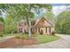 Charming two-story brick home featuring a landscaped yard and black shutters, surrounded by lush trees at 918 Guinevere Way, Lilburn, GA 30047