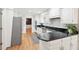 Bright kitchen with white cabinets, stainless steel appliances, and dark countertops at 918 Guinevere Way, Lilburn, GA 30047