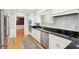 Modern kitchen with stainless steel appliances and black countertops at 918 Guinevere Way, Lilburn, GA 30047