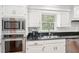 Modern kitchen with stainless steel appliances and black countertops at 918 Guinevere Way, Lilburn, GA 30047
