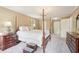 Inviting main bedroom with four-poster bed, side tables, and a chandelier creating a relaxed ambiance at 918 Guinevere Way, Lilburn, GA 30047
