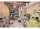 Cluttered storage room with exposed brick walls, shelves, and various tools and equipment at 918 Guinevere Way, Lilburn, GA 30047