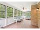 Bright sunroom featuring many windows with views of nature, wooden floors, and comfortable seating at 918 Guinevere Way, Lilburn, GA 30047