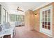 Inviting sunroom with brick accents and plenty of natural light at 918 Guinevere Way, Lilburn, GA 30047