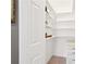 Neat walk-in closet featuring white shelving and ample storage space, maximizing organization at 918 Guinevere Way, Lilburn, GA 30047