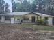 Modest single-story brick home with mature trees and a covered front porch at , Stockbridge, GA 30281