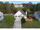 Aerial view of a two-story home featuring mature trees and a fenced yard at 1389 Shadow Creek Ave, Hampton, GA 30228
