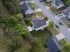 Aerial view of house showing location in a wooded neighborhood with privacy fence at 1389 Shadow Creek Ave, Hampton, GA 30228