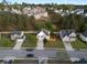 Aerial view of a home surrounded by lush trees in a suburban neighborhood at 1389 Shadow Creek Ave, Hampton, GA 30228