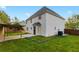 Large backyard featuring a covered patio area and green lawn at 1389 Shadow Creek Ave, Hampton, GA 30228