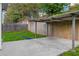 Backyard with covered parking, green grass and privacy fence at 1389 Shadow Creek Ave, Hampton, GA 30228