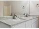 Close-up of bathroom counter with granite counters and brushed metal plumbing at 1389 Shadow Creek Ave, Hampton, GA 30228