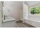 Bathroom boasts double sinks, stylish tub, and tiled shower at 1389 Shadow Creek Ave, Hampton, GA 30228