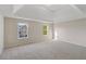 Spacious bedroom featuring large windows and tray ceiling at 1389 Shadow Creek Ave, Hampton, GA 30228
