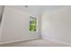 Bright bedroom with plush carpeting, neutral walls, and a large window providing natural light at 1389 Shadow Creek Ave, Hampton, GA 30228
