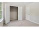 Bedroom with plush carpeting, closet with opened doors, neutral walls, and a window providing plenty of natural light at 1389 Shadow Creek Ave, Hampton, GA 30228