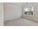 Bedroom with large window and neutral carpet at 1389 Shadow Creek Ave, Hampton, GA 30228