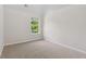 Bright bedroom with plush carpeting, neutral walls, and a window providing plenty of natural light at 1389 Shadow Creek Ave, Hampton, GA 30228