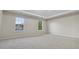 Bright, airy bedroom with large windows and plush carpeting at 1389 Shadow Creek Ave, Hampton, GA 30228