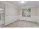 Bright dining room with wainscoting and a view to the kitchen and an adjacent room at 1389 Shadow Creek Ave, Hampton, GA 30228