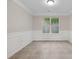 Elegant dining room featuring wainscoting and large windows for abundant natural light at 1389 Shadow Creek Ave, Hampton, GA 30228