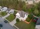 Aerial view of a well-maintained home with a lush lawn and an orange privacy fence at 1389 Shadow Creek Ave, Hampton, GA 30228