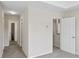 Hallway leads to various rooms and a bathroom with a tiled floor at 1389 Shadow Creek Ave, Hampton, GA 30228