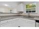 Well-lit kitchen featuring granite countertops and ample cabinet space at 1389 Shadow Creek Ave, Hampton, GA 30228