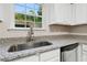 Bright kitchen features granite countertops, stainless steel sink, and ample cabinet space at 1389 Shadow Creek Ave, Hampton, GA 30228
