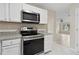 Modern kitchen with stainless steel appliances, granite countertops, and white cabinets at 1389 Shadow Creek Ave, Hampton, GA 30228