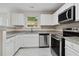 Modern kitchen featuring white cabinets, stainless steel appliances, and granite countertops at 1389 Shadow Creek Ave, Hampton, GA 30228