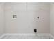 Spacious laundry room with tile flooring, washer and dryer hookups, and overhead shelving at 1389 Shadow Creek Ave, Hampton, GA 30228