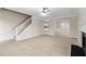Bright living room with tile floors, a fireplace, and stairs leading to the upper level at 1389 Shadow Creek Ave, Hampton, GA 30228
