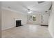 Cozy living room with fireplace, tile flooring, and ample natural light at 1389 Shadow Creek Ave, Hampton, GA 30228