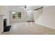 Bright living room featuring a fireplace, tile flooring, and large window at 1389 Shadow Creek Ave, Hampton, GA 30228