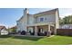Covered patio with comfortable seating, grill area, and lush lawn provides the perfect outdoor living space at 209 Crestmont Way, Canton, GA 30114