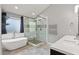 Modern bathroom featuring a soaking tub, a glass shower, and dual sinks at 209 Crestmont Way, Canton, GA 30114