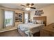 Bedroom with wooden bed frame, ceiling fan, natural light, and neutral tones at 209 Crestmont Way, Canton, GA 30114