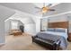 Large bedroom with a tray ceiling, ceiling fan, and seating area at 209 Crestmont Way, Canton, GA 30114