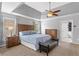 Bedroom featuring a tray ceiling, a ceiling fan, a bed, and two nightstands at 209 Crestmont Way, Canton, GA 30114