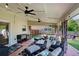 Inviting covered patio featuring comfortable seating, ceiling fans, and an outdoor grill, ideal for relaxation at 209 Crestmont Way, Canton, GA 30114