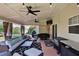 Covered patio with ceiling fans, comfortable seating, and a grill area, perfect for outdoor entertaining at 209 Crestmont Way, Canton, GA 30114