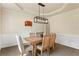 Charming dining area featuring a rustic wood table and a modern, linear chandelier, perfect for Gathering gatherings at 209 Crestmont Way, Canton, GA 30114