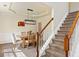 View of the dining area and staircase, showcasing the home's layout and wainscoting details at 209 Crestmont Way, Canton, GA 30114
