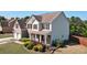 Beautiful two-story home with brick and siding, lush landscaping, and a welcoming front porch at 209 Crestmont Way, Canton, GA 30114