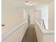 Spacious hallway with plush carpeting and view of a bathroom with tile shower at 209 Crestmont Way, Canton, GA 30114