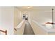 Upstairs hallway with carpet, white railing and trim, and ceiling fan at 209 Crestmont Way, Canton, GA 30114
