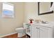 Bright half bath features updated vanity, mirror, window, and wood-look floor at 209 Crestmont Way, Canton, GA 30114