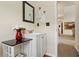 A stylish powder room with elegant sink, mirror, and a glimpse into the home at 209 Crestmont Way, Canton, GA 30114