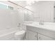 Bright bathroom with a shower-tub, white tiles, and modern vanity at 2139 Briar Glen Sw Ln, Atlanta, GA 30331